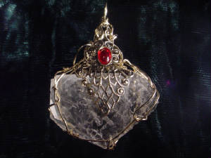 A Freeform Quartz Crystal Filigree And Wire Wrapped With A 10X8 Siam Ruby Czech Glass Cabochon