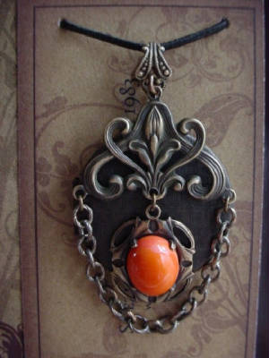 An Oxidized Brass Locket Embellished With Filigree, Chain And A Tango Coral Swarovski Crystal 12x10 Cabochon